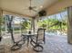 Relaxing screened-in patio with ceiling fan, outdoor seating, and views of the private pool at 15254 Bellamy Rd, Tampa, FL 33625