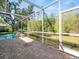 Spacious brick patio with screened-in lanai overlooking the scenic backyard at 15254 Bellamy Rd, Tampa, FL 33625