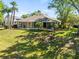 Spacious screened lanai overlooks the lush backyard and mature tropical landscaping, offering great privacy at 15254 Bellamy Rd, Tampa, FL 33625