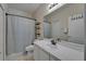 Bathroom features a white vanity, large mirror, and a shower with patterned curtain at 15825 Fishhawk View Dr, Lithia, FL 33547