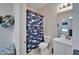 ' bathroom with whale-themed shower curtain and white vanity at 15825 Fishhawk View Dr, Lithia, FL 33547