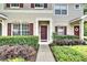 Inviting townhome entrance with well-maintained landscaping and a charming front door at 15825 Fishhawk View Dr, Lithia, FL 33547