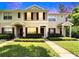 Charming townhome with manicured lawn and colorful shutters under a vibrant sky at 15825 Fishhawk View Dr, Lithia, FL 33547