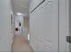 Hallway with carpet and white closet doors, offering ample storage space at 15825 Fishhawk View Dr, Lithia, FL 33547