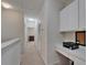 Well-lit hallway featuring a built-in desk with cabinets, perfect for a home office space at 15825 Fishhawk View Dr, Lithia, FL 33547