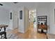 Bright hallway featuring hardwood floors, archways, and stylish shelving units at 15825 Fishhawk View Dr, Lithia, FL 33547