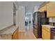 Modern kitchen seamlessly connects to the entryway, with stainless steel appliances and light cabinets at 15825 Fishhawk View Dr, Lithia, FL 33547