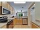 Kitchen featuring stainless steel appliances, modern countertops, and light wood cabinets at 15825 Fishhawk View Dr, Lithia, FL 33547