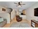 Cozy living room with ceiling fan, leather furniture, and view of the kitchen at 15825 Fishhawk View Dr, Lithia, FL 33547