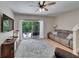 This living room has wood flooring, a comfortable couch, and a view of the patio at 15825 Fishhawk View Dr, Lithia, FL 33547