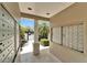 Mailbox area with view of the community pool, palm trees, and blue skies at 15825 Fishhawk View Dr, Lithia, FL 33547