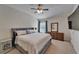 Cozy main bedroom with neutral tones, ceiling fan, and a window for natural light at 15825 Fishhawk View Dr, Lithia, FL 33547