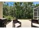This patio has two chairs and faces a lush green space at 15825 Fishhawk View Dr, Lithia, FL 33547