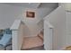 Carpeted staircase with white banister leads to the upper level, illuminated by natural light at 15825 Fishhawk View Dr, Lithia, FL 33547