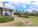 Expansive backyard featuring a serene pond, screened lanai, and lush landscaping for outdoor enjoyment at 15939 Fishhawk View Dr, Lithia, FL 33547