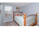 Cozy bedroom with soft carpet and natural light from the large window at 15939 Fishhawk View Dr, Lithia, FL 33547
