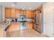 An open kitchen featuring stainless steel appliances, granite countertops, and tile flooring at 15939 Fishhawk View Dr, Lithia, FL 33547
