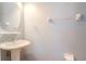 Powder room features a pedestal sink and a round mirror at 15939 Fishhawk View Dr, Lithia, FL 33547