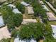 Aerial view of a community surrounded by lush greenery and mature trees at 1616 Laughton Pl, Sun City Center, FL 33573