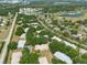 An aerial view of a charming neighborhood with mature trees and a winding road leading to a tranquil lake and golf course at 1616 Laughton Pl, Sun City Center, FL 33573