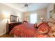 Cozy bedroom with wood-look floors, ceiling fan, and a dresser with decorative lamps at 1616 Laughton Pl, Sun City Center, FL 33573