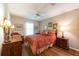 A bedroom features a bed, wood flooring, chair, and two side tables at 1616 Laughton Pl, Sun City Center, FL 33573