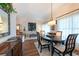 Elegant dining area with a large table, chandelier lighting, and neutral decor at 1616 Laughton Pl, Sun City Center, FL 33573