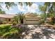 Charming single-story home featuring a two-car garage, well-kept lawn, and mature landscaping at 1616 Laughton Pl, Sun City Center, FL 33573