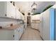 Functional kitchen with white cabinets, tile flooring, and ample counter space at 1616 Laughton Pl, Sun City Center, FL 33573