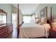 A main bedroom features a four-poster bed, wood flooring, and neutral decor at 1616 Laughton Pl, Sun City Center, FL 33573