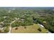Aerial view of sprawling acreage with a large outbuilding, mature trees, and a long driveway at 1691 Ridge Top Dr, Tarpon Springs, FL 34688