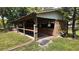 A barn with open stalls and a wheelbarrow outside blends function and farm living at 1691 Ridge Top Dr, Tarpon Springs, FL 34688