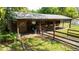 A horse barn with stalls and a door painted with a horse head offers a tranquil rural retreat at 1691 Ridge Top Dr, Tarpon Springs, FL 34688
