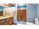 Bathroom featuring double doors, a sink, and a toilet at 1691 Ridge Top Dr, Tarpon Springs, FL 34688