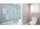Renovated bathroom with a glass shower enclosure, modern fixtures, and soft grey walls at 1691 Ridge Top Dr, Tarpon Springs, FL 34688