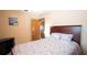 Comfortable bedroom featuring a bed, a side table, and an entryway to the next room at 1691 Ridge Top Dr, Tarpon Springs, FL 34688