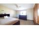 Bright bedroom features a comfortable bed, dresser, and closet with neutral colors and soft carpet at 1691 Ridge Top Dr, Tarpon Springs, FL 34688