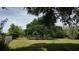 Sprawling green field with a large, mature tree offers scenic views and ample shade at 1691 Ridge Top Dr, Tarpon Springs, FL 34688