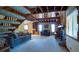Spacious living room with fireplace, wood beam ceiling, and a view of the staircase to the loft at 1691 Ridge Top Dr, Tarpon Springs, FL 34688