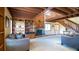 Open living room features include wood beam ceiling, stone fireplace, built in shelves and staircase at 1691 Ridge Top Dr, Tarpon Springs, FL 34688