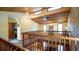 Loft view with multiple windows, wood paneled accent wall and ceiling, overlooking the living room at 1691 Ridge Top Dr, Tarpon Springs, FL 34688
