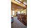 Loft overlooking the living room showcases the wood beam ceiling and accent wall with many windows at 1691 Ridge Top Dr, Tarpon Springs, FL 34688