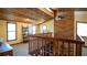 Upper level featuring a warm wooden ceiling, natural light, and an open railing overlooking the living area at 1691 Ridge Top Dr, Tarpon Springs, FL 34688