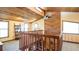 Loft area showing wood paneled ceiling, natural light, and staircase looking down into living room at 1691 Ridge Top Dr, Tarpon Springs, FL 34688