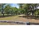 Open pasture with scattered trees and fencing offers a tranquil and rural setting at 1691 Ridge Top Dr, Tarpon Springs, FL 34688