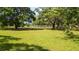 Spacious grassy pasture lined with trees and white fencing, great for horses or livestock at 1691 Ridge Top Dr, Tarpon Springs, FL 34688