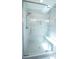 Modern tiled shower featuring glass door, built in bench and niche at 1691 Ridge Top Dr, Tarpon Springs, FL 34688