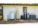 Home utility panel includes a water softener, water heater, and air conditioning units at 1691 Ridge Top Dr, Tarpon Springs, FL 34688