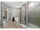 Bright bathroom featuring a glass-enclosed shower, soaking tub, and stylish decor at 17320 Nokota Ave, Hudson, FL 34667