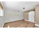 Bedroom featuring wood floors, a ceiling fan, and a barn door for a closet at 208 Ne Lincoln N Cir, St Petersburg, FL 33702